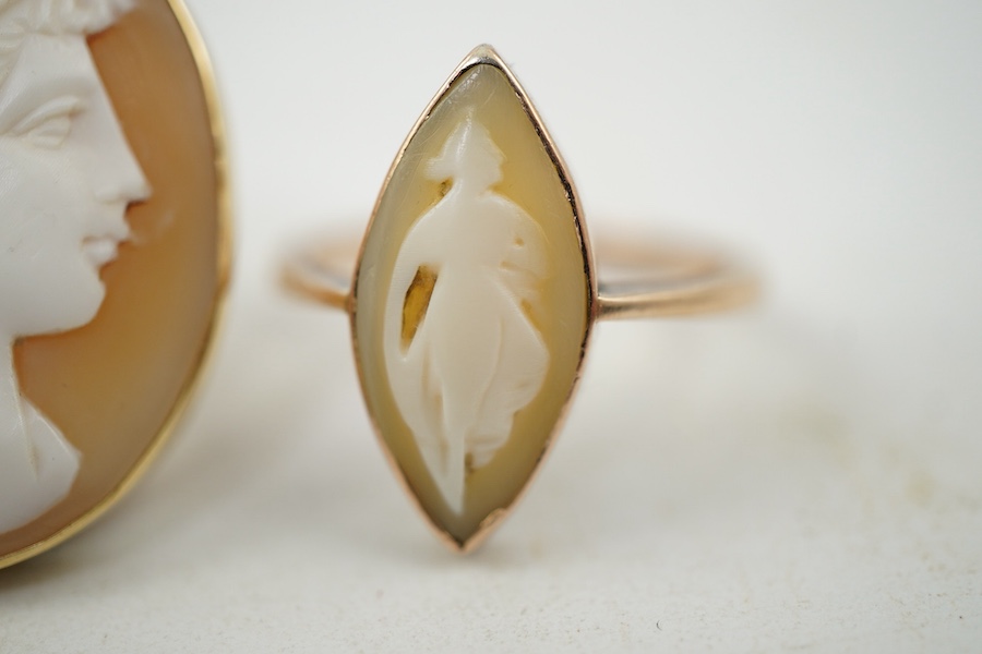 A group of three shell cameo rings, two depicting a classical lady in profile, one of navette-shaped outline depicting a dancing figure, each mounted in gold, two stamped 9ct, largest size V, largest cameo 3 x 2.4cm, com